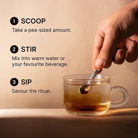 Hand holding a jar of shilajit in a product photoshoot